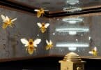 A mystical interior space where golden bees with glowing wings swarm inside a dimly lit room. The bees leave trails of light as they hover near a floating beehive, which pulses with energy. The scene is both calming and eerie, symbolizing balance between productivity and potential chaos. The walls are covered in intricate honeycomb patterns.
