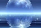 A tranquil dreamscape where an endless crystal-clear lake reflects a massive glowing full moon. The water’s surface is undisturbed, except for a single ripple that expands infinitely. Small floating lanterns drift on the surface, symbolizing clarity, peace, and deep introspection. The colors are soft blues and silvers, creating a calming yet mysterious aura.